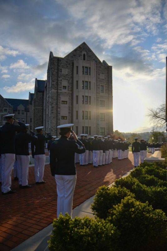 Cadets saluting at dusk